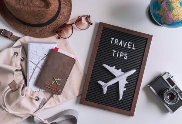 Retro camera with  toy plane, map and passport on white background, Travel tips concept