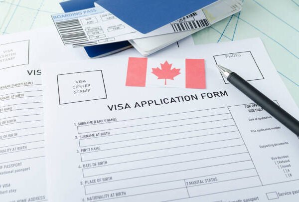 Visa application form, passports, tickets,English flag, magnifying glass on the world map.Concept of cheking documents to get a visa
